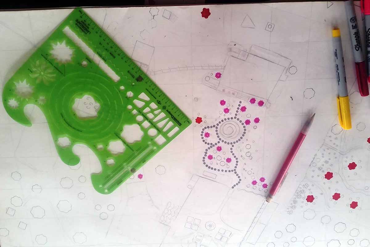 Image horizontale en gros plan d'un croquis d'un jardin sur une feuille de papier blanche.